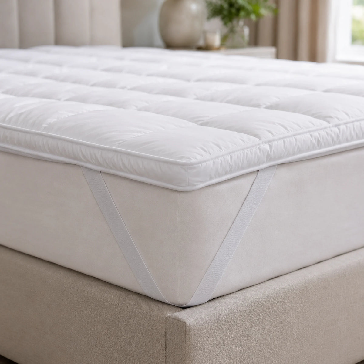 Elasticated corner strap securing a Double mattress topper to the mattress