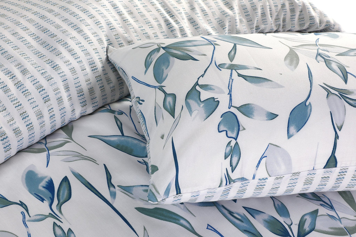 Close-up of blue and grey leaf print pillowcase with textured stripe fabric detail
