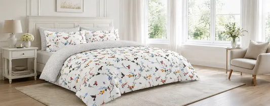 Floral duvet cover styled in a bright modern UK bedroom with white sheets, neutral decor and soft natural light.