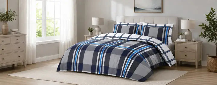 Modern UK bedroom styled with navy, grey and blue gingham bedding, solid navy cushions and soft neutral decor.