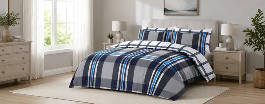 Modern UK bedroom styled with navy, grey and blue gingham bedding, solid navy cushions and soft neutral decor.