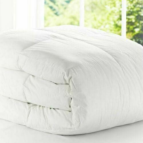 Folded white 15 tog duvet with soft-touch cotton cover, showing its thick quilted loft