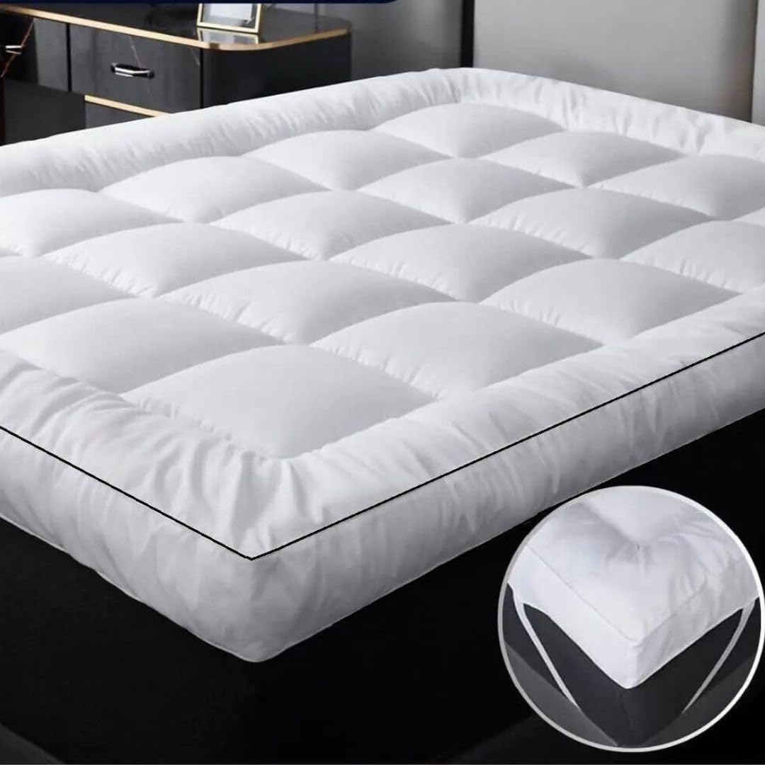 4ft mattress topper fitted with elasticated corner straps on a small double mattress