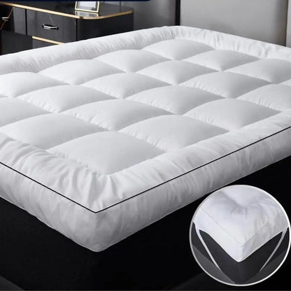4ft mattress topper fitted with elasticated corner straps on a small double mattress