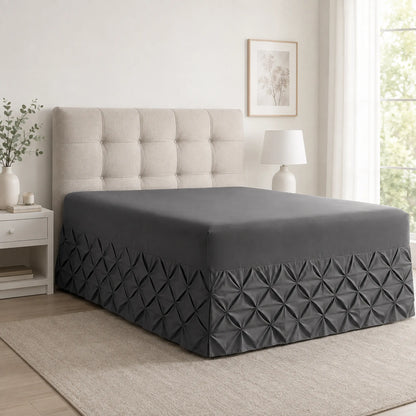 Charcoal pintuck fitted valance sheet on a bed