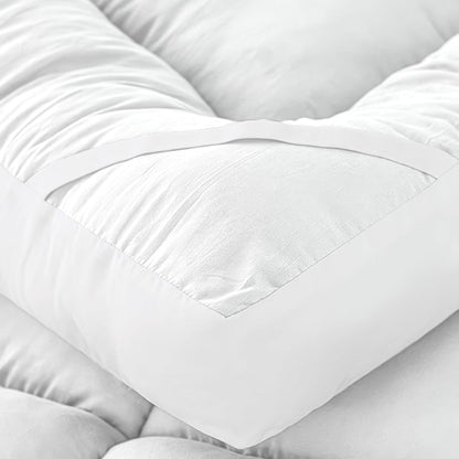 Double bed mattress topper close-up showing soft quilted padding and elastic strap