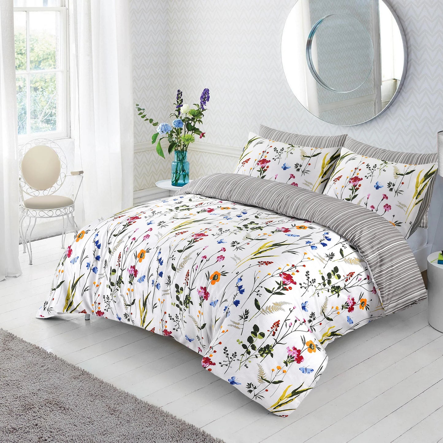 Floral duvet cover set with colourful wildflower and butterfly print styled on a bed