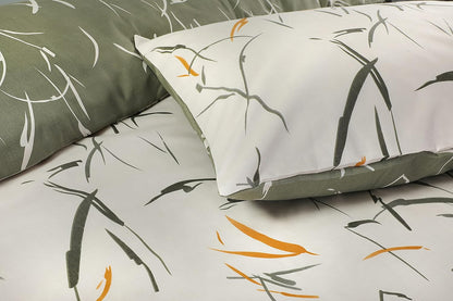 Close-up of Green Leaves bedding showing white pillowcase with sage brushstroke leaves over sage reverse