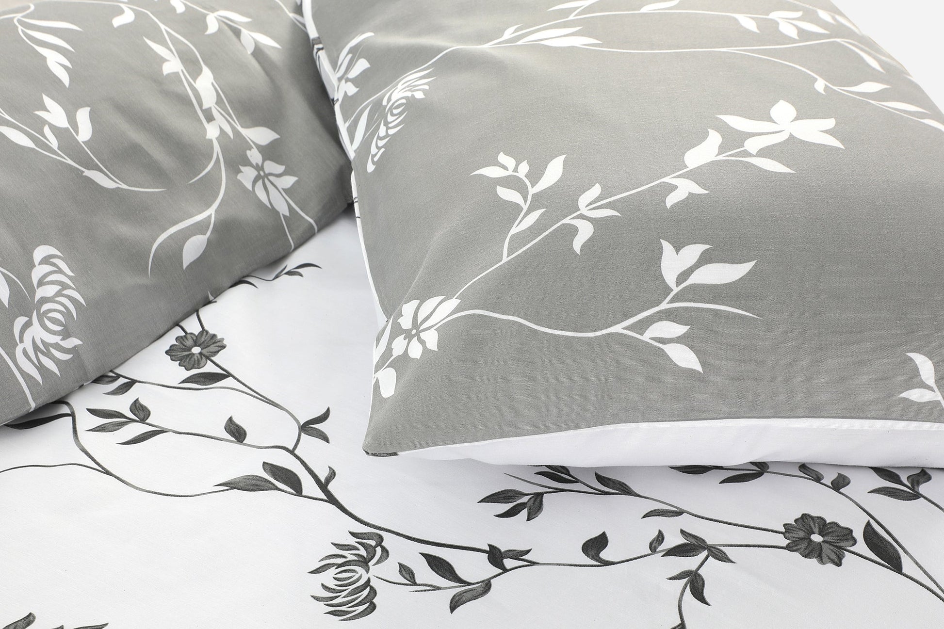 Close-up of grey floral duvet cover set showing vine and flower print detail
