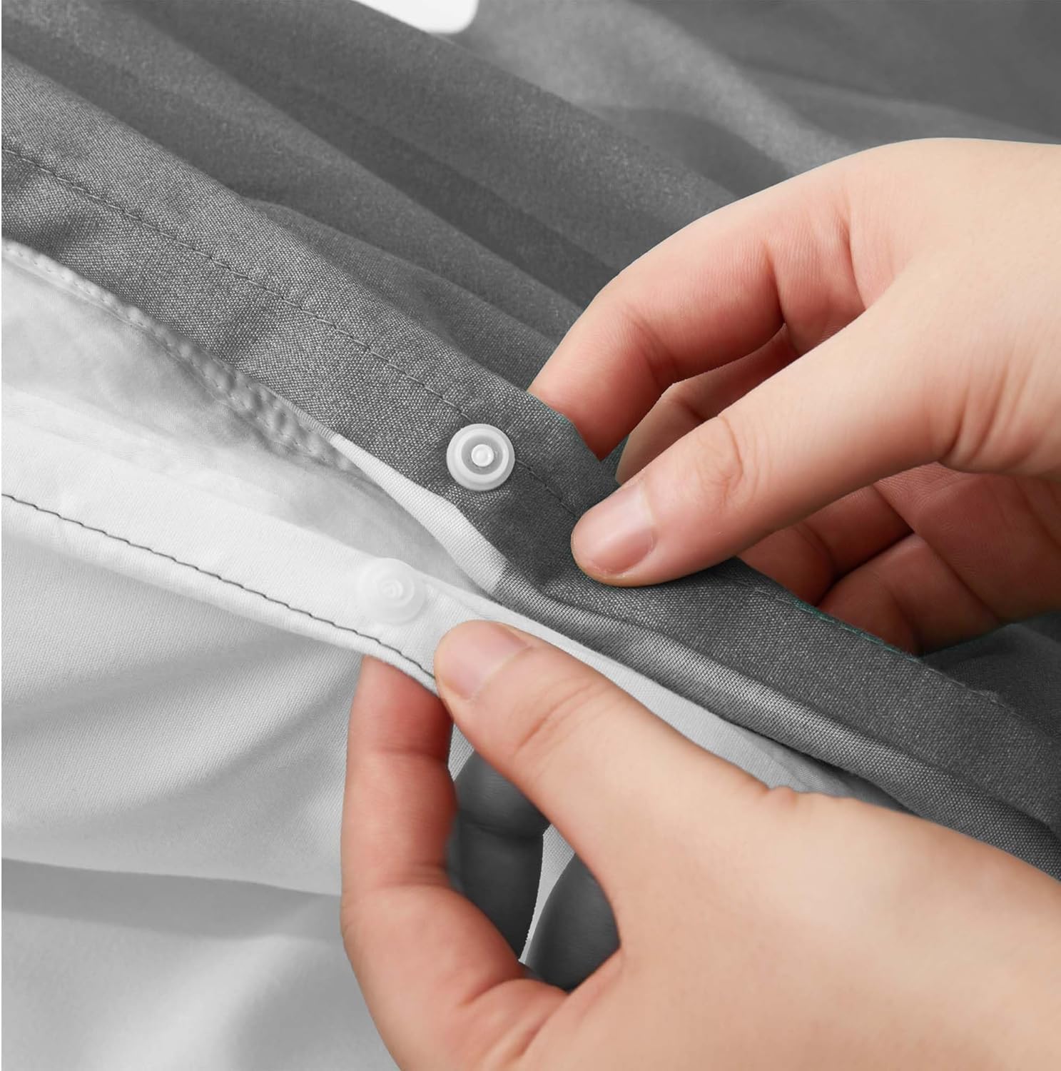 Close-up of poppers closure fastening on grey floral duvet cover set