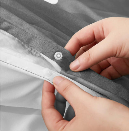 Close-up of poppers closure fastening on grey floral duvet cover set