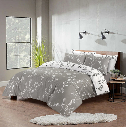 Grey floral duvet cover set with white vine print styled on a bed