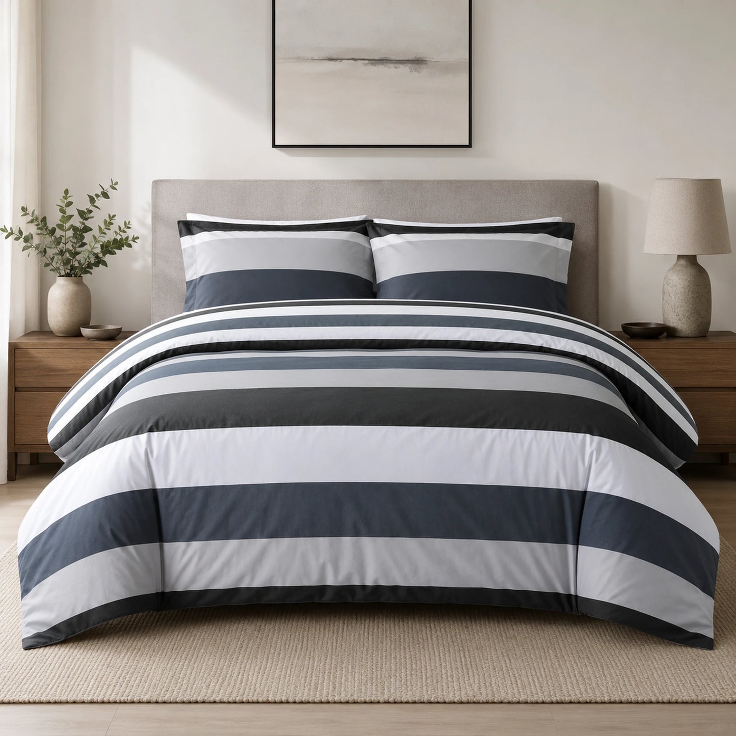 Grey, black and white striped duvet cover set styled on a bed