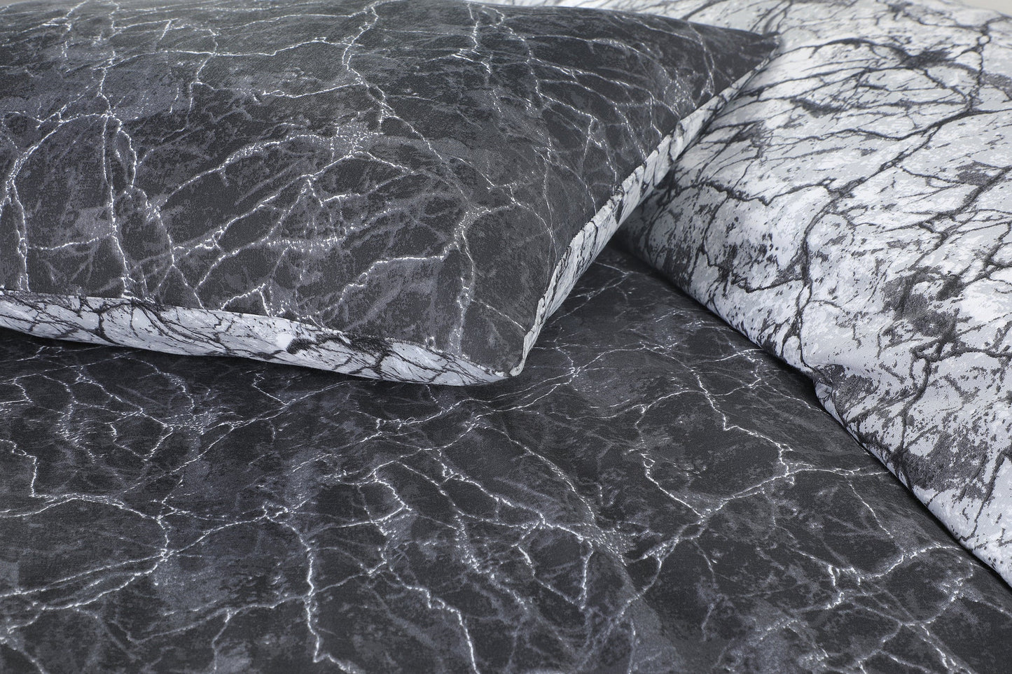 Close-up of charcoal and black marble print fabric detail on duvet cover and pillowcase