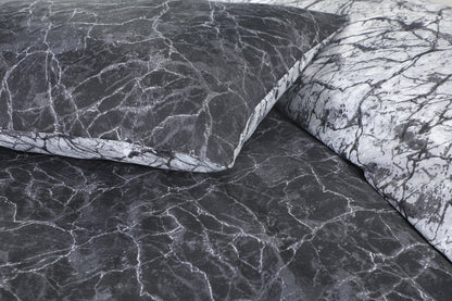 Close-up of charcoal and black marble print fabric detail on duvet cover and pillowcase