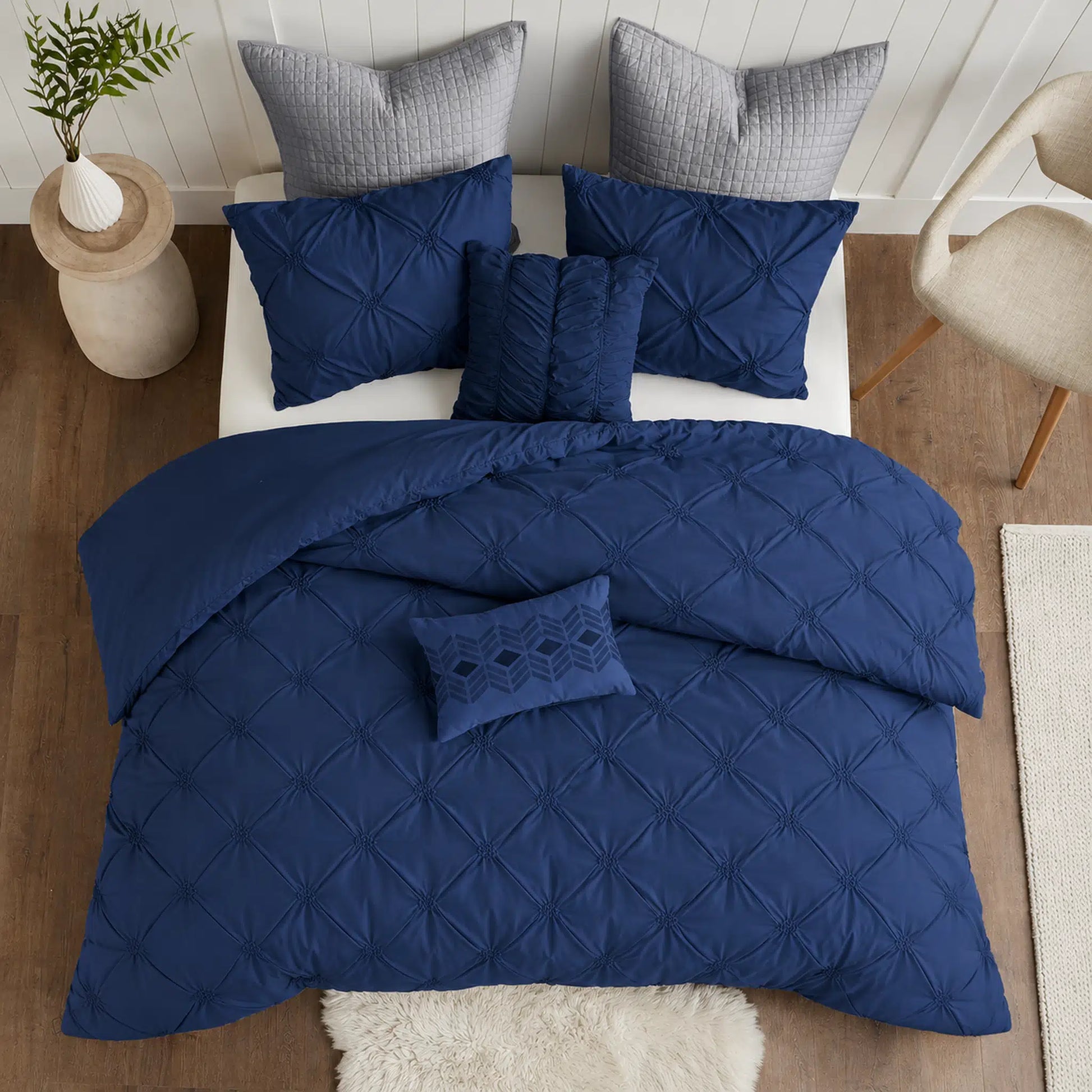 Navy Diamond Pintuck Duvet Cover Set with an all-over gathered pattern on a bed