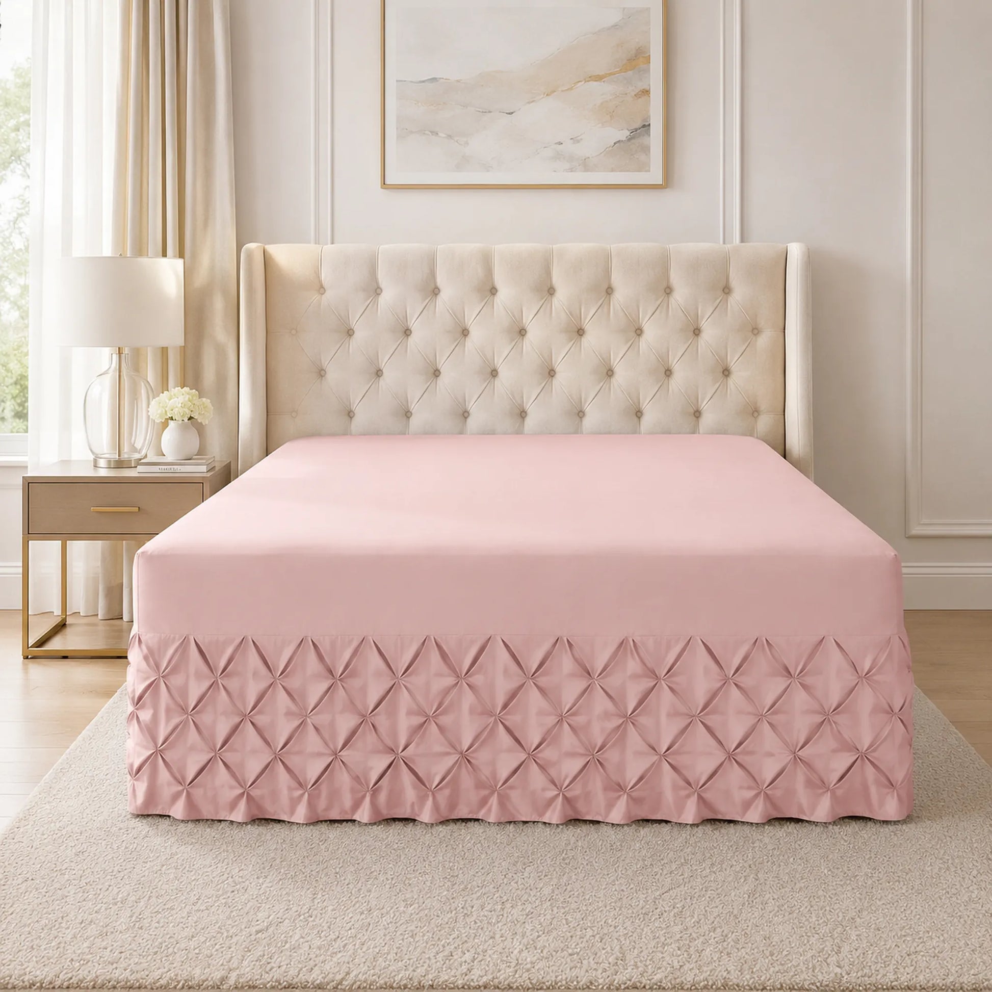 Pink pintuck fitted valance sheet on a bed