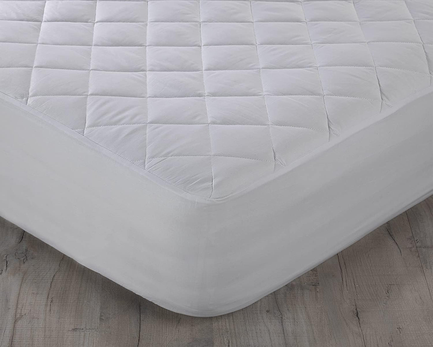 Quilted mattress protector fitted securely around mattress corner