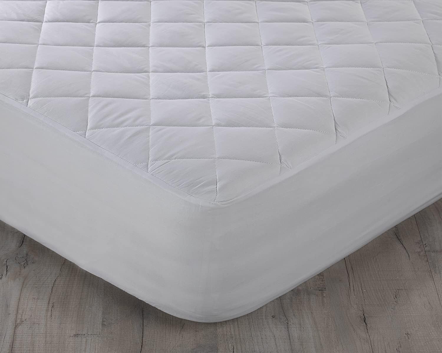 Quilted mattress protector fitted securely around mattress corner