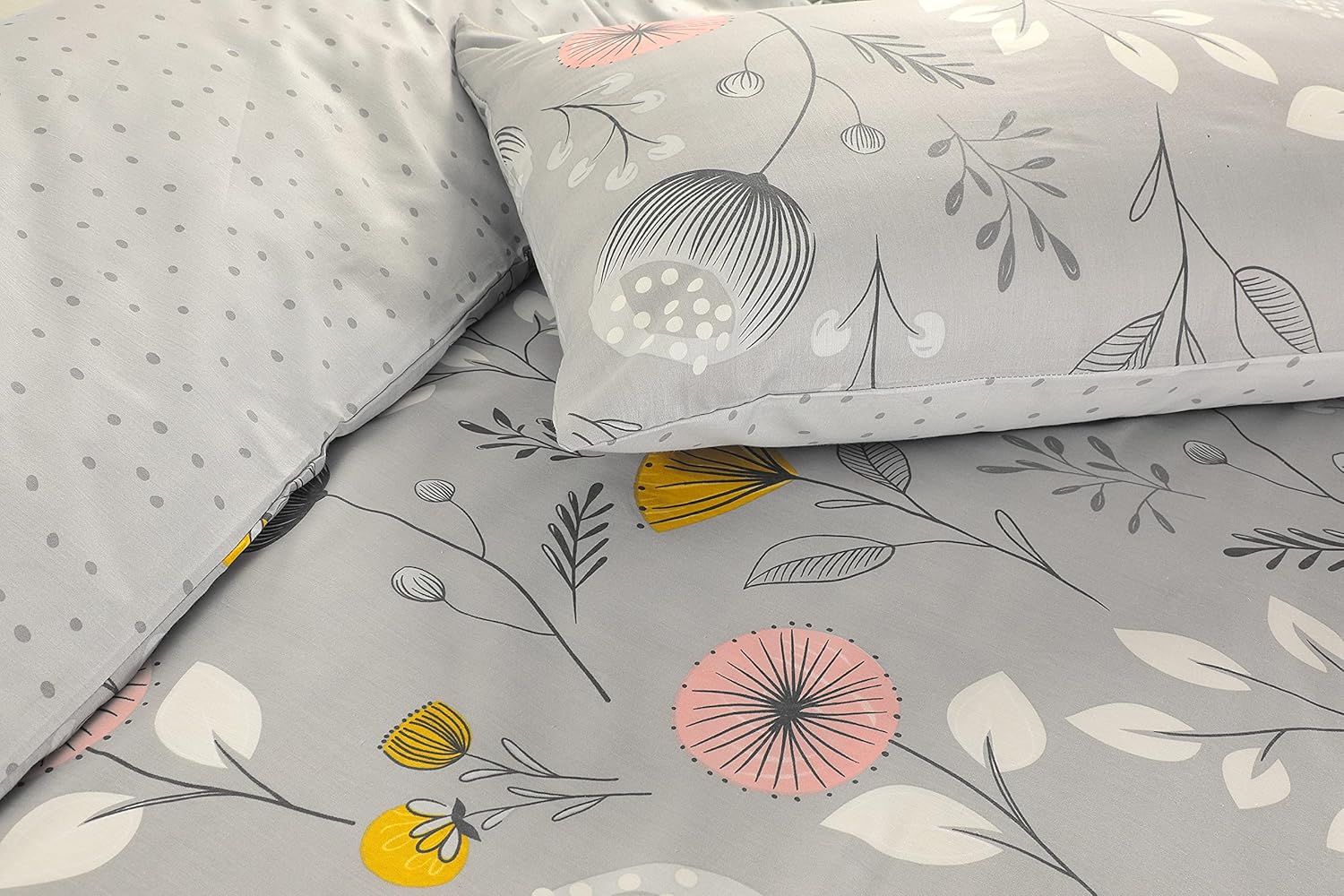 Close-up of grey floral duvet cover set showing wildflower print and reverse polka dot pillowcase