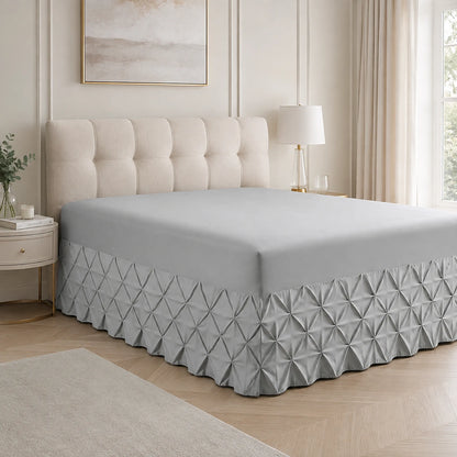Silver Grey pintuck fitted valance sheet on a bed