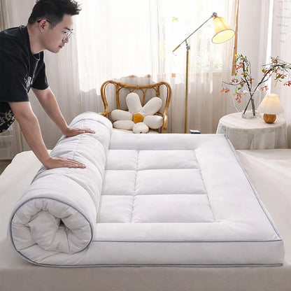 Single mattress topper being rolled out on bed