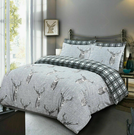 Silver grey stag print duvet cover set styled on a bed with matching pillowcases
