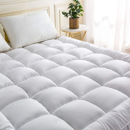 Super king mattress topper with soft quilted comfort layer on bed