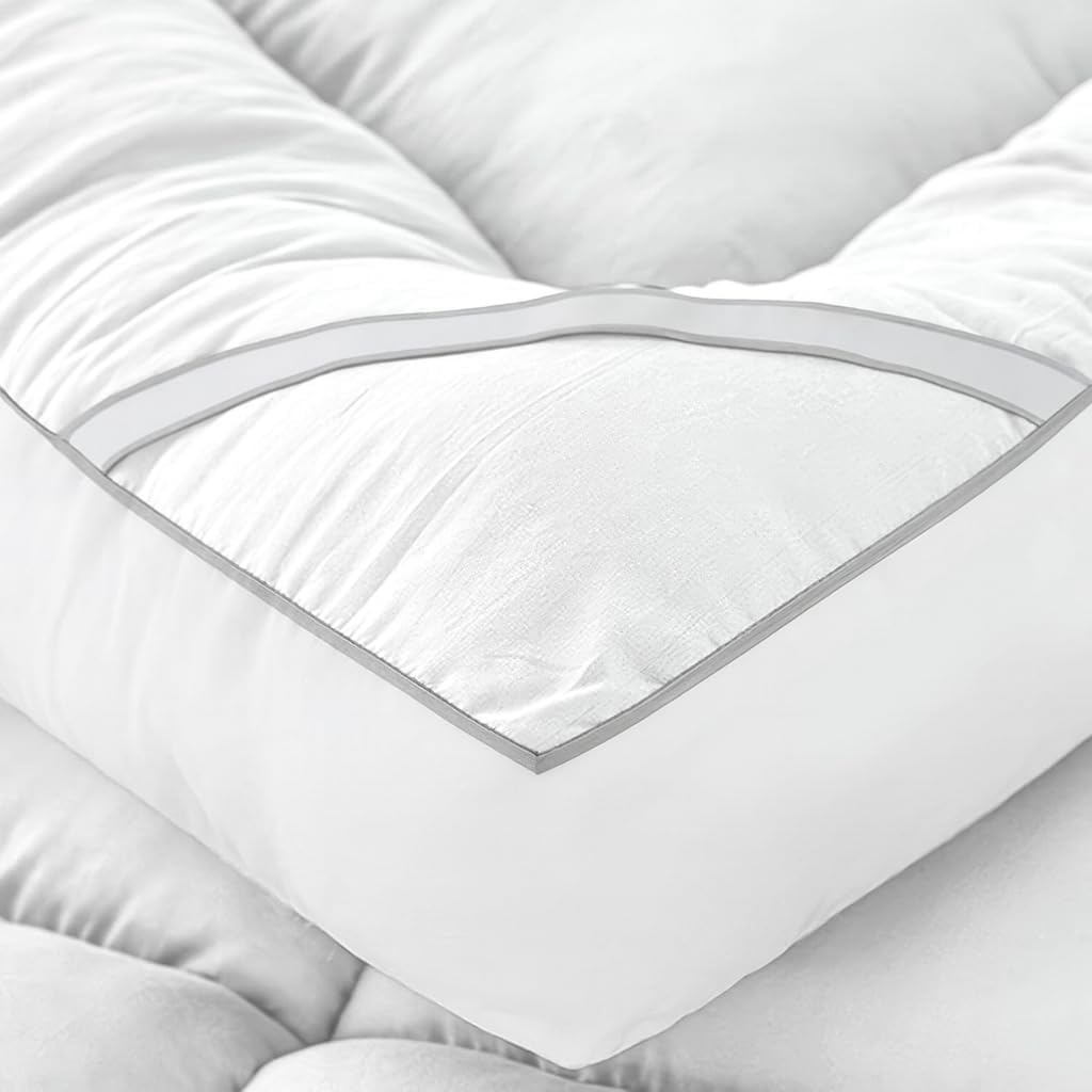 Close-up of super king mattress topper with quilted padding and piped edge