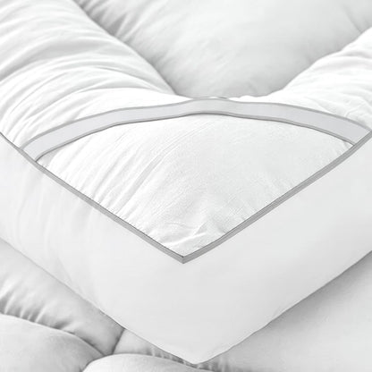Close-up of super king mattress topper with quilted padding and piped edge