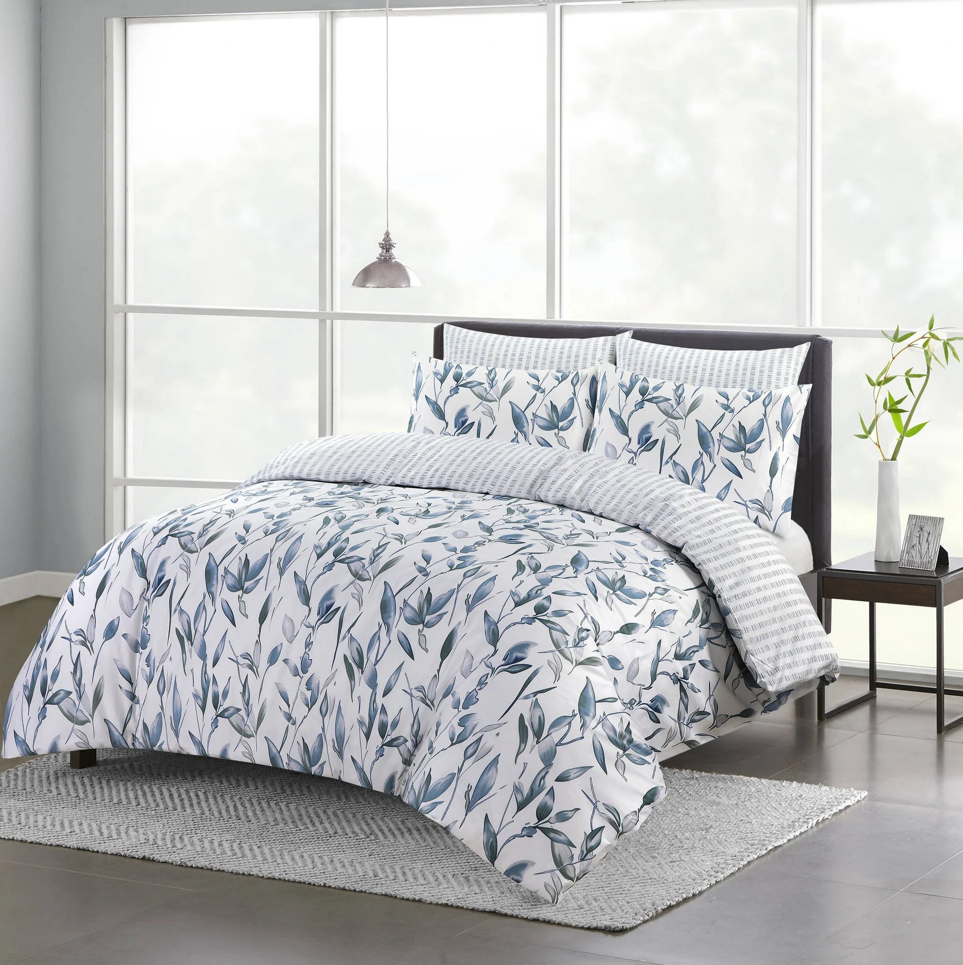 Vintage Blue duvet cover set with blue and grey botanical leaf print styled on a bed