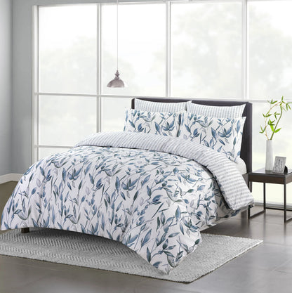 Vintage Blue duvet cover set with blue and grey botanical leaf print styled on a bed