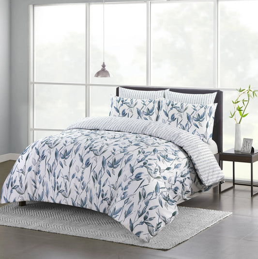 Vintage Blue duvet cover set with blue and grey botanical leaf print styled on a bed