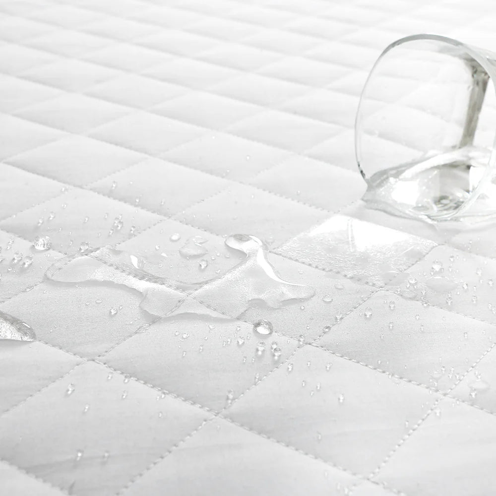 Waterproof pillow protector showing liquid protection on quilted surface