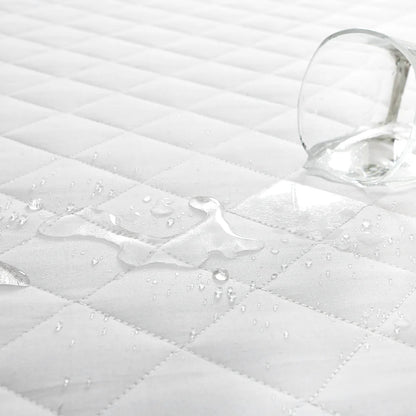 Waterproof pillow protector showing liquid protection on quilted surface