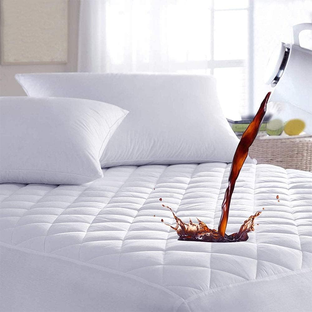 Waterproof quilted mattress protector protecting bed from liquid spill