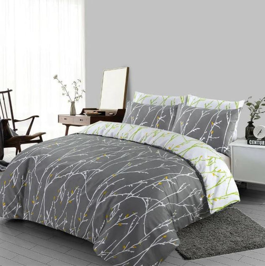 Grey reversible duvet cover set with white branch print styled on a bed