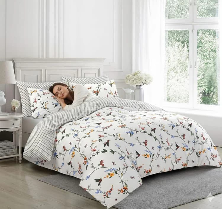 Woman sleeping on white floral duvet cover set with hummingbird print