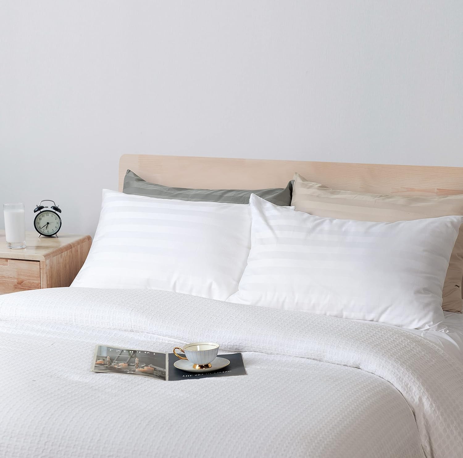 White stripe pillows styled on a bed for a hotel-style bedroom